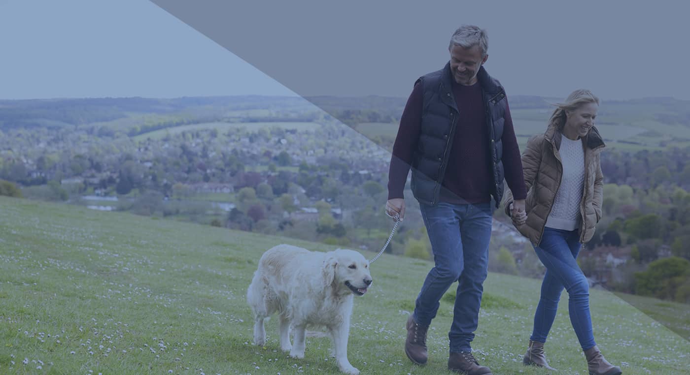 couple walking dog